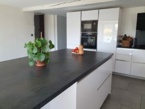 Coin repas convivial dans la cuisine du gîte en Ariège, table en bois et chaises confortables à Mirepoix