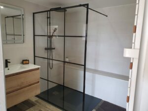 Vue de la salle d’eau du gîte en Ariège, attenante à la chambre du rez-de-chaussée avec meuble vasque et douche